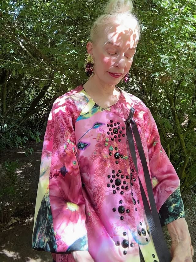 Taking pictures in dappled sunlight. Wearing a beautiful top gifted to me by Norwegian designer @tina_haagensen . Tina and I met in Oslo pre pandemic. She’s an amazing designer. Avant- guard, boho chic with medieval witchery! Intricate details. Handmade. Luxurious to wear. One of a kind. Tina, and her designs! We’re having gorgeous weather right now. The grey skies have disappeared until November. I hope your weather is gorgeous too! And, hey! Don’t you forget those everyday bits of magic, just waiting to amaze you......#bohochicstyle #gorgeousinpink #dappledsunlight #summerdays #uniquedesigner by @ruth.yunker