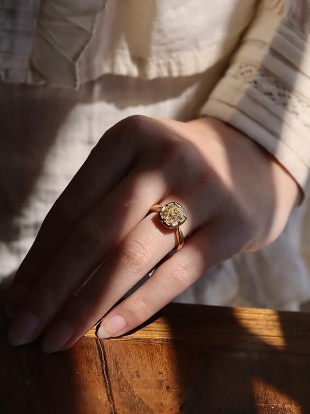A L L I E 3 . 8 3 ☀️🕯️🫶🏼 Elongated, chunky, and golden-hued- this Old Mine Cut diamond has all the charm we seek in an antique stone! The high crown, broad faceting, and open culet all come together to create the most beautiful play of light. The diamond is set in our Georgian-inspired collet setting for more old-world flair, while the comfortable, tapered band hugs the finger for everyday wearability. •••#antiquediamond #omc #oldminecut #engagementring #ringinspo by @andriabarbonejewelry