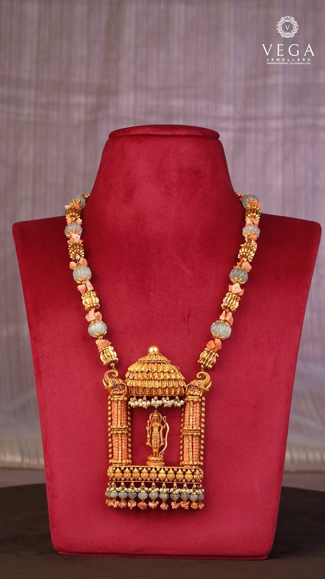 🏹 Wear the Symbol of Dharma: The Sri Rama Heritage PendantEmbody strength, virtue, and timeless devotion. ✨Carry divine inspiration wherever you go with this extraordinary heritage masterpiece from Vega Jewellers. This intricately handcrafted antique gold necklace features a majestic Lord Rama pendant standing beautifully beneath a temple dome. The unique statement chain seamlessly weaves together premium carved green melon beads, natural pink coral accents, and ornate gold spacers.A powerful fusion of spiritual devotion and royal craftsmanship, designed to be treasured for lifetimes. 🙏👑💎 Product HighlightsMotif: Hand-sculpted Lord Rama Temple PendantCraftsmanship: Antique Gold Finish with Delicate Pearl HangingsBead Profile: Natural Coral Nuggets & Carved Sage-Green Melon Beads📍 Visit Us / Order OnlineDiscover our complete Divine Heritage Collection at your nearest showroom or connect with our luxury consultants online:Vijayawada | Hyderabad | Kakinada | Eluru | Guntur🌐 vegajewellers.com📞 +91 99899 43625#VegaJewellers #TempleJewellery #LordRamaPendant #AntiqueGoldNecklace #HeritageJewelry #CoralJewelry #SouthIndianJewellery #HyderabadJewellers #VijayawadaShopping #GunturFashion #TraditionalGoldJewelry #divinejewellery by @vegajewellers_jubileehills